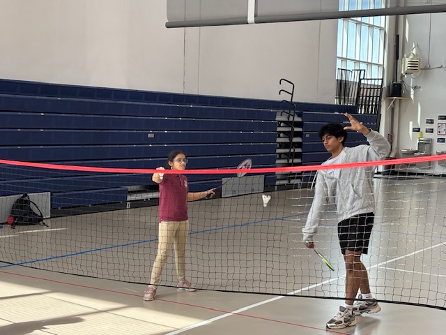 Coach and student at the net