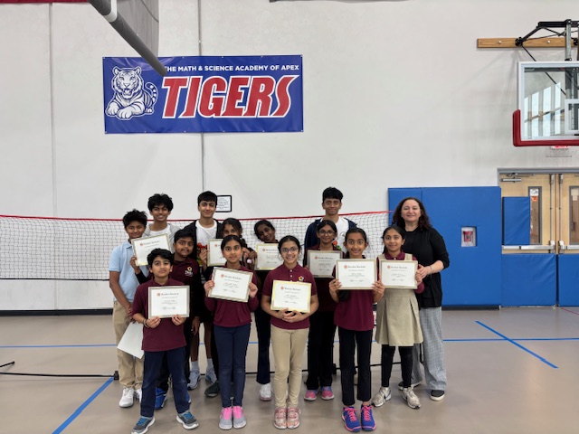 Participants holding certificates at the end of a Rookie Rackets workshop